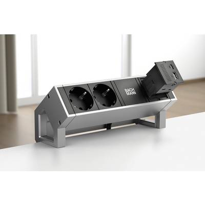 Distributore di corrente su un tavolo con due prese elettriche e un modulo con connettore HDMI. Ambiente luminoso e moderno sullo sfondo.