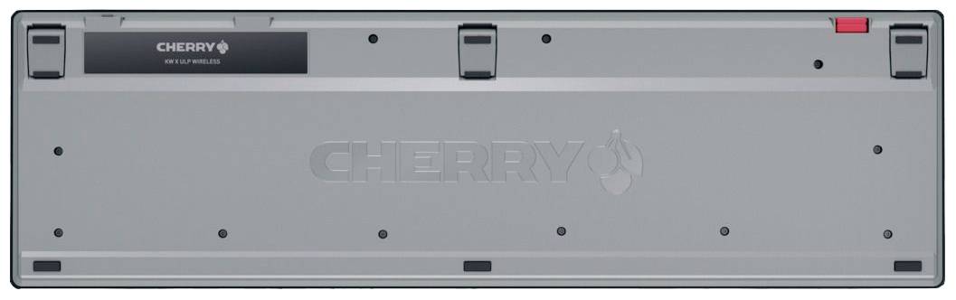 Il retro di una tastiera CHERRY mostra il logo, un'etichetta ed elementi rossi. Uno sguardo alla struttura meccanica della tastiera.