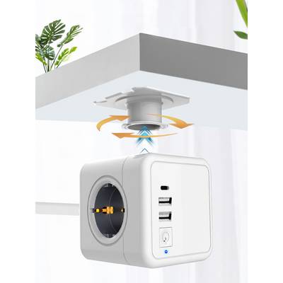 Una multipresa con porte USB viene montata magneticamente sotto un tavolo. I cavi fuoriescono dalla presa. Delle piante sono sullo sfondo.