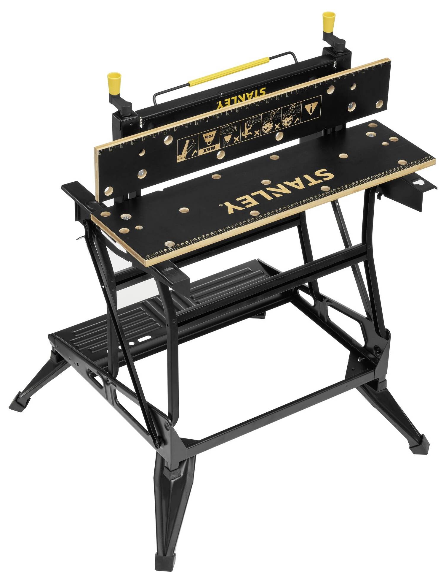 Banco da lavoro pieghevole nero con logo 'Stanley' giallo sulla superficie di lavoro e visualizzazione di simboli di sicurezza; costruzione portatile.