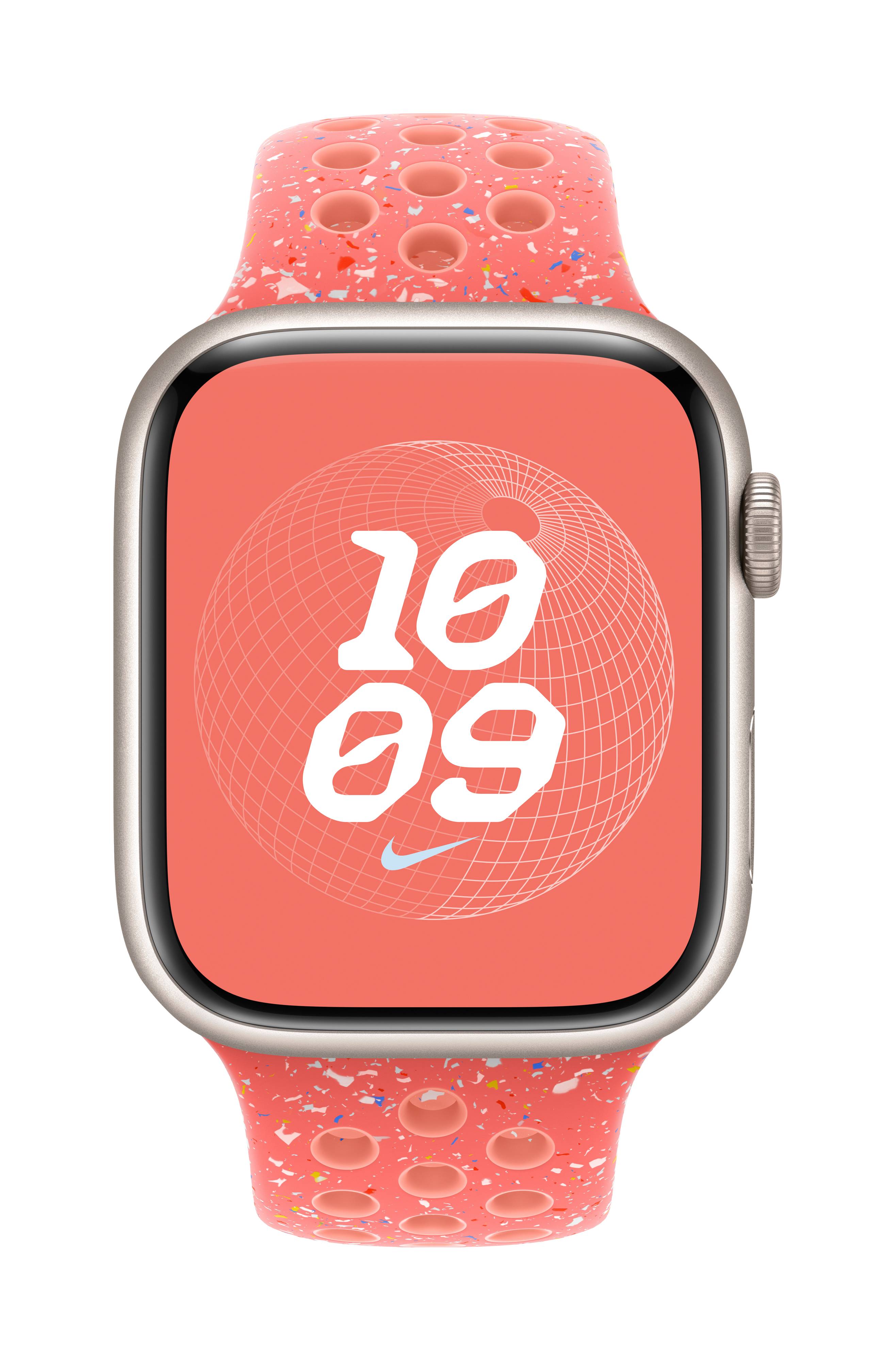 Smartwatch con quadrante rotondo che mostra '10:09'. Lo sfondo del display ha un motivo geometrico. Il cinturino è rosso con fori.