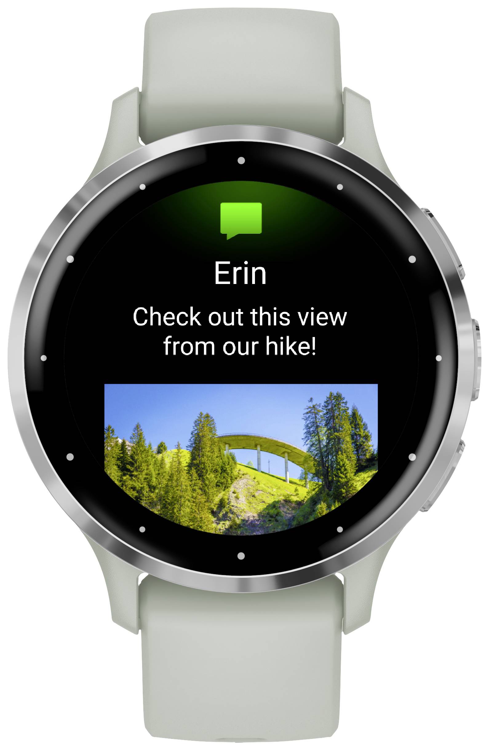 Lo smartwatch mostra un messaggio di 'Erin' con il testo 'Guarda questa vista dal nostro trekking!' e una foto di un ponte in un paesaggio montuoso sullo sfondo.