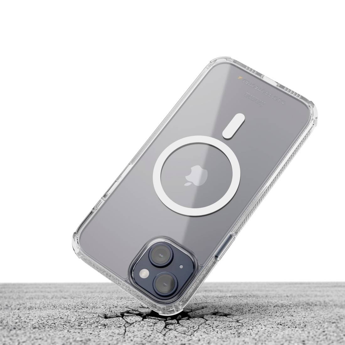 Smartphone con custodia trasparente che galleggia sopra un pavimento screpolato, con messa a fuoco sulla lente della fotocamera e sul retro con design circolare.