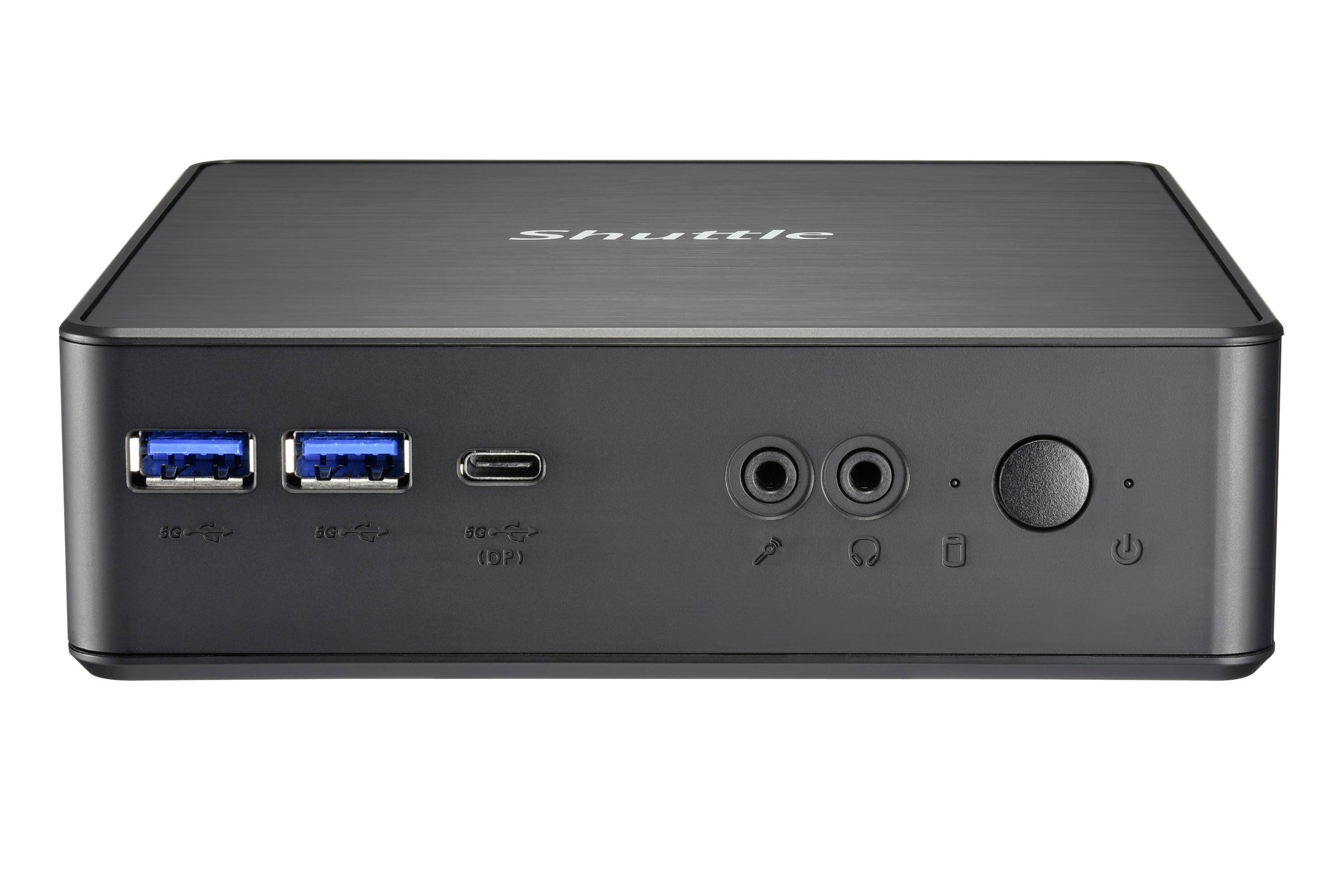 Mini PC nero con logo 'Shuttle' sul davanti, due porte USB, jack per cuffie e microfono, e un interruttore di accensione.