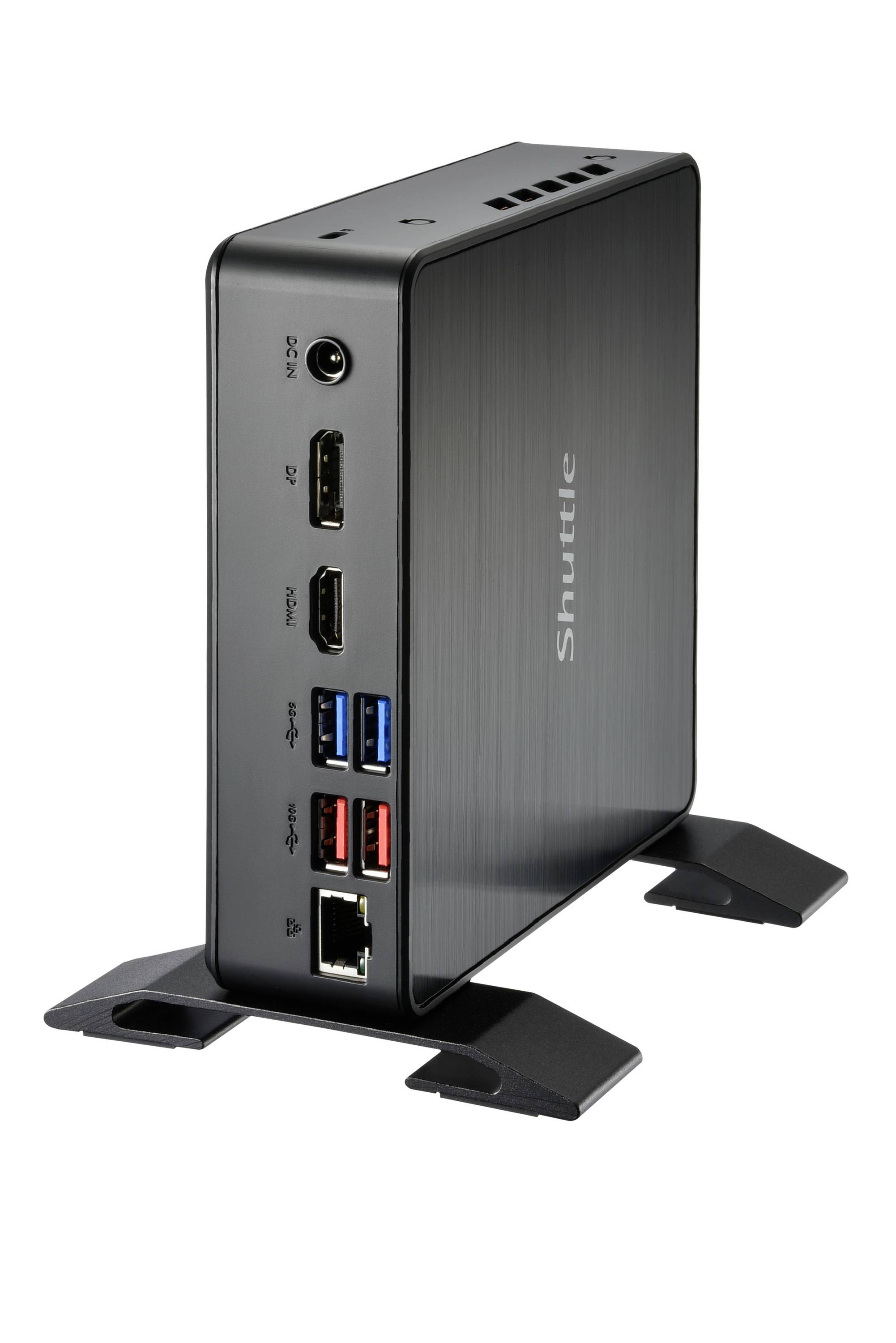 Un mini PC compatto nero con diverse opzioni di connettività è posizionato verticalmente su un tavolo.