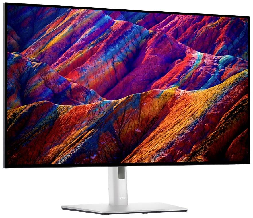 Un monitor mostra un'immagine di montagne frastagliate e colorate in intense tonalità di rosso, arancione e blu.