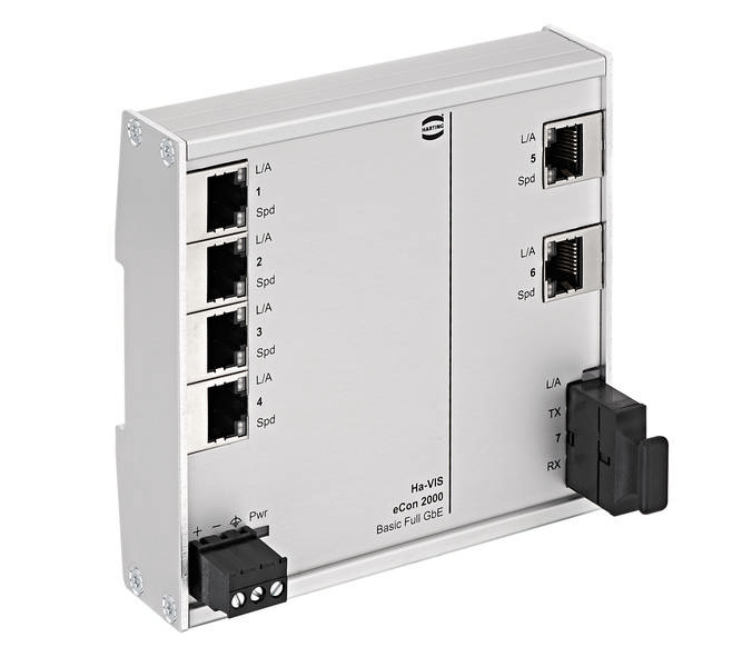 Un interruttore di rete argentato con più porte Ethernet e un ingresso di alimentazione. Quattro porte sono visibili a sinistra, due a destra.