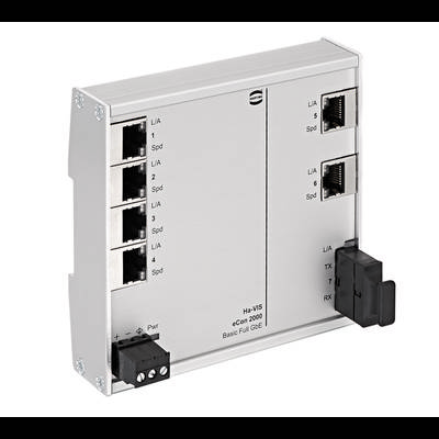 Un interruttore di rete argentato con più porte Ethernet e un ingresso di alimentazione. Quattro porte sono visibili a sinistra, due a destra.