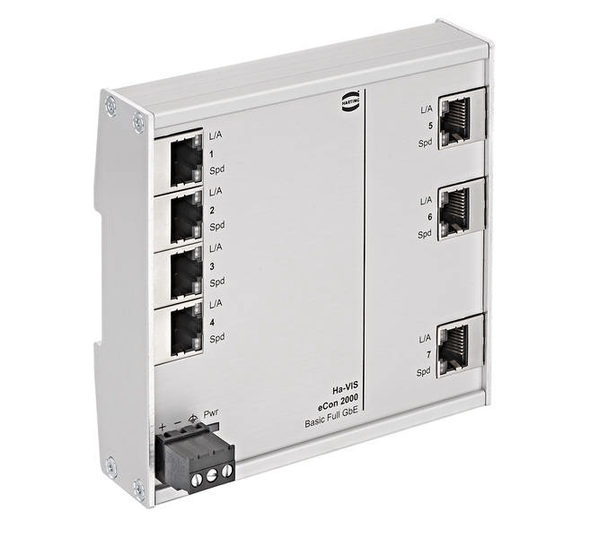 Un interruttore Ethernet argentato con otto porte RJ-45, numerate da 1 a 8. In basso a sinistra un piccolo connettore di alimentazione nero.