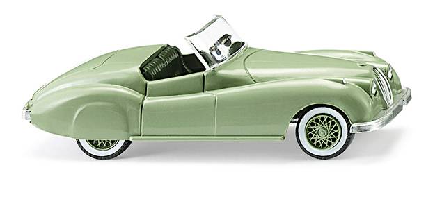 Un'auto giocattolo classica color verde chiaro in stile cabrio con cerchi in argento.