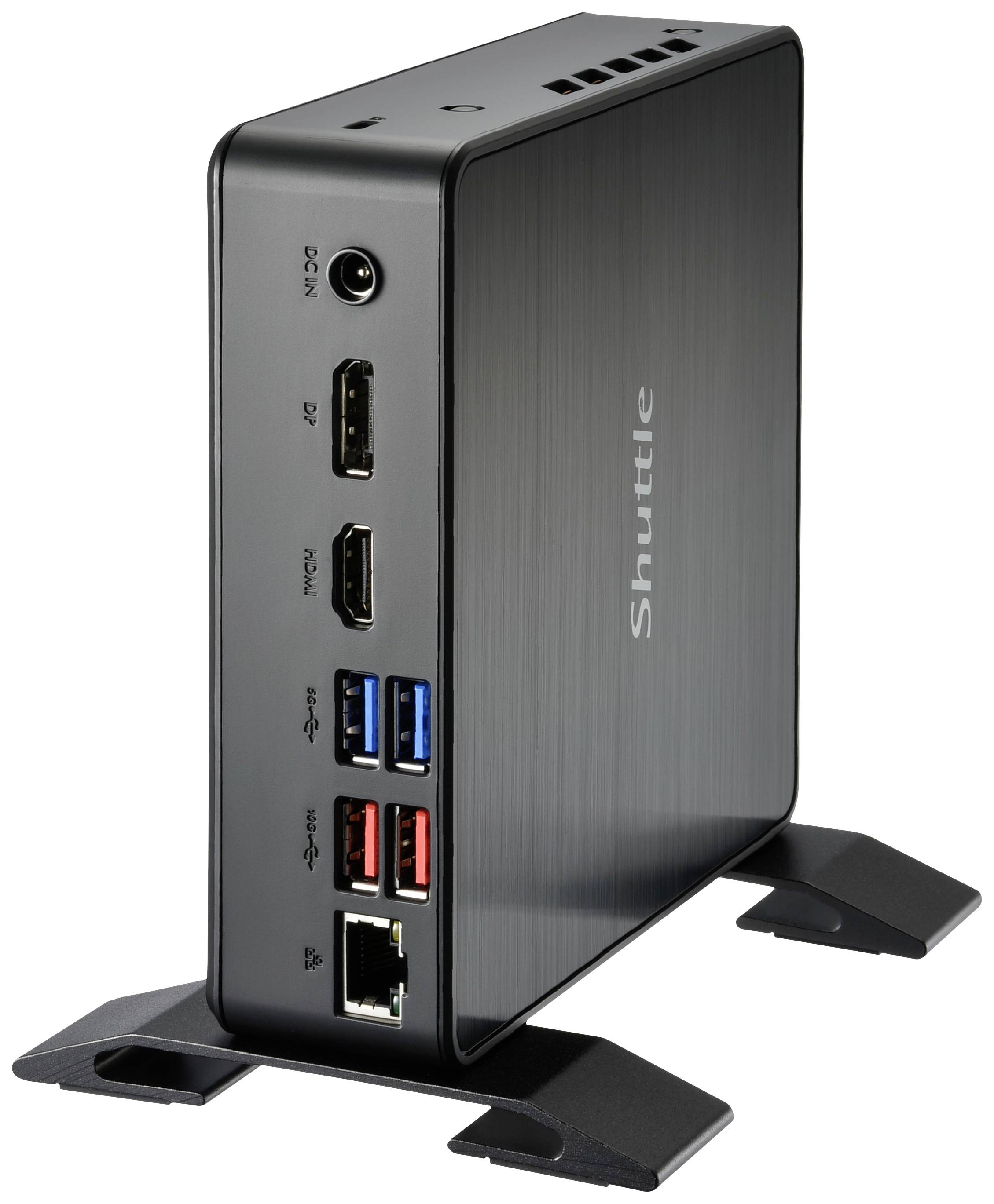 Mini PC nero su piedini, pannello laterale con porte USB, HDMI, DisplayPort ed Ethernet. Marca: Shuttle.