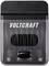Caricabatterie del marchio 'Voltcraft' con un involucro trasparente, in grado di contenere più batterie. Sulla parte superiore sono riportati 'Input' e 'Output'.