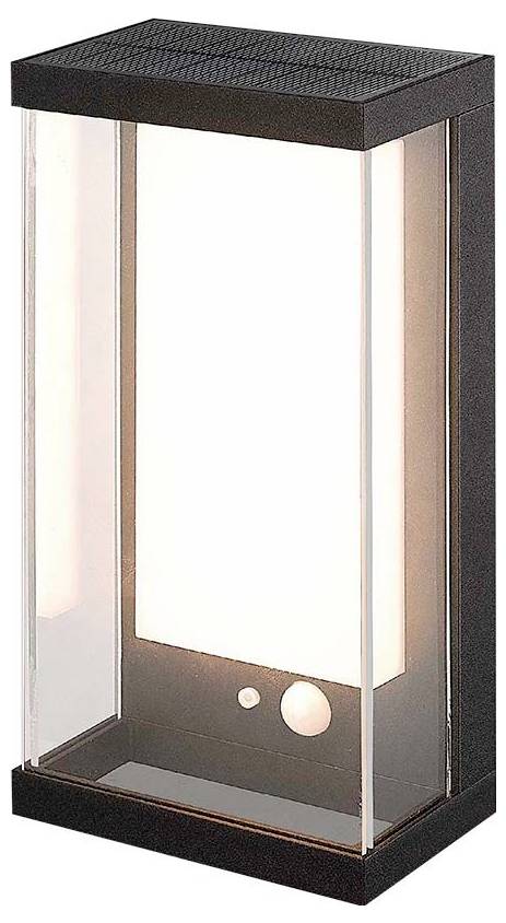 Lampada da esterno nera di forma rettangolare con copertura in vetro trasparente, attraverso la quale una luce calda bianca si irradia dolcemente.
