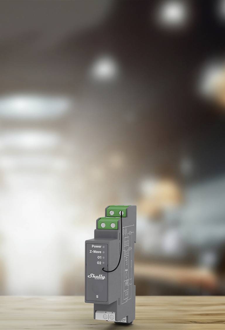 Un dispositivo grigio di un relè Shelly su uno sfondo sfocato. Adatto per l'automazione domestica e il monitoraggio energetico.