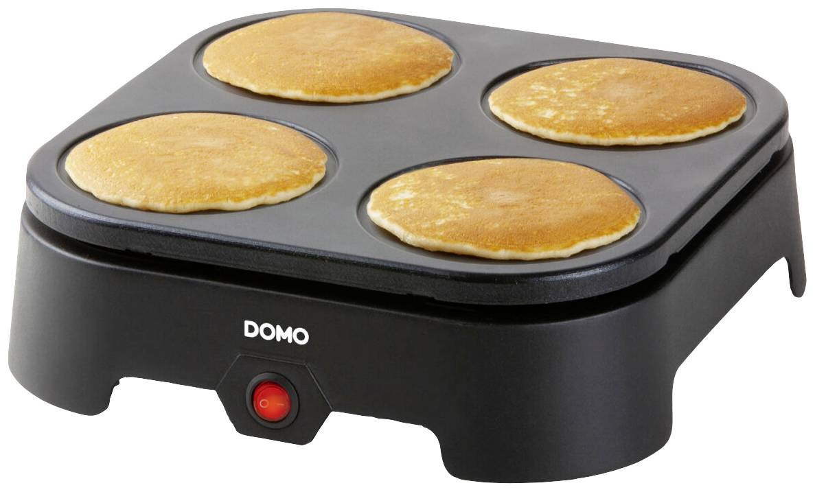Un dispositivo elettrico per pancake con quattro pancake dorati e croccanti sulla piastra di cottura, pronti per essere serviti.