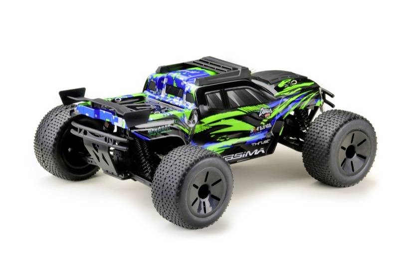Un monster truck telecomandato, dipinto con colori vivaci, con grandi ruote e un design sgargiante, è fermo su una superficie.