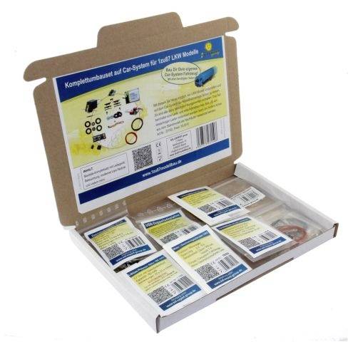 Kit completo di conversione per Car-System in una scatola di cartone aperta, contiene vari componenti e istruzioni per modelli di camion.