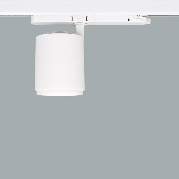 Una plafoniera da incasso bianca con un design moderno su sfondo grigio. È cilindrica e dal design minimale.