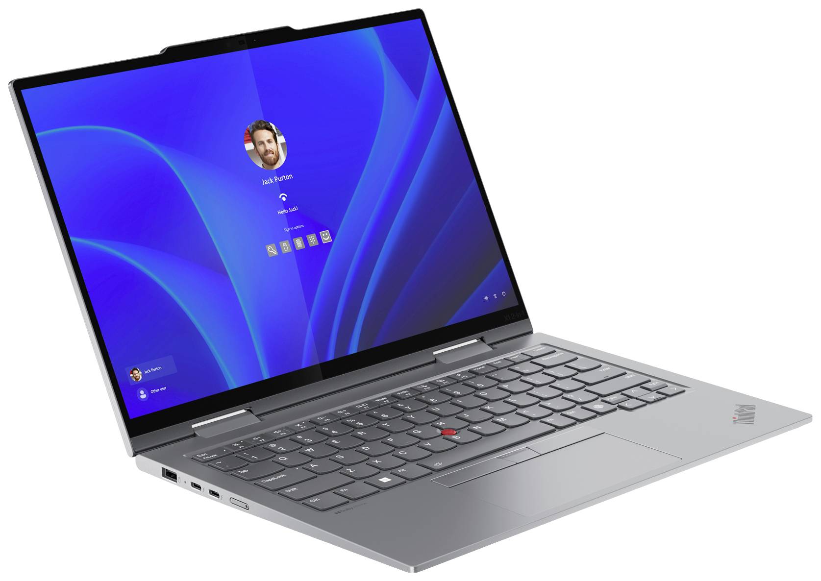 Un laptop aperto che mostra la schermata di accesso con sfondo blu e foto dell'utente, pronto per l'inserimento della password.