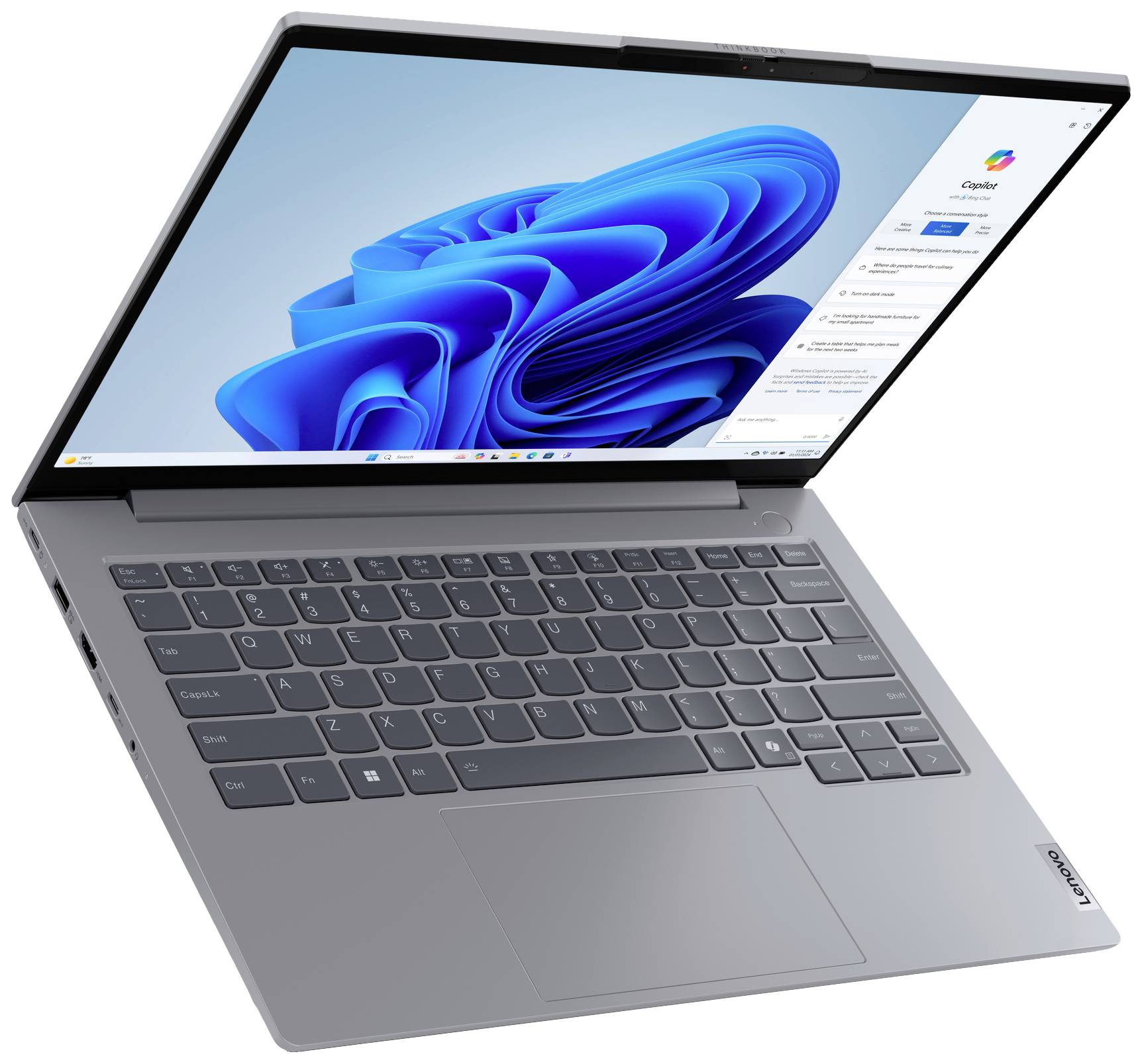 Un laptop aperto con tastiera antracite, che mostra un sistema operativo moderno sullo schermo con grafica di sfondo blu.