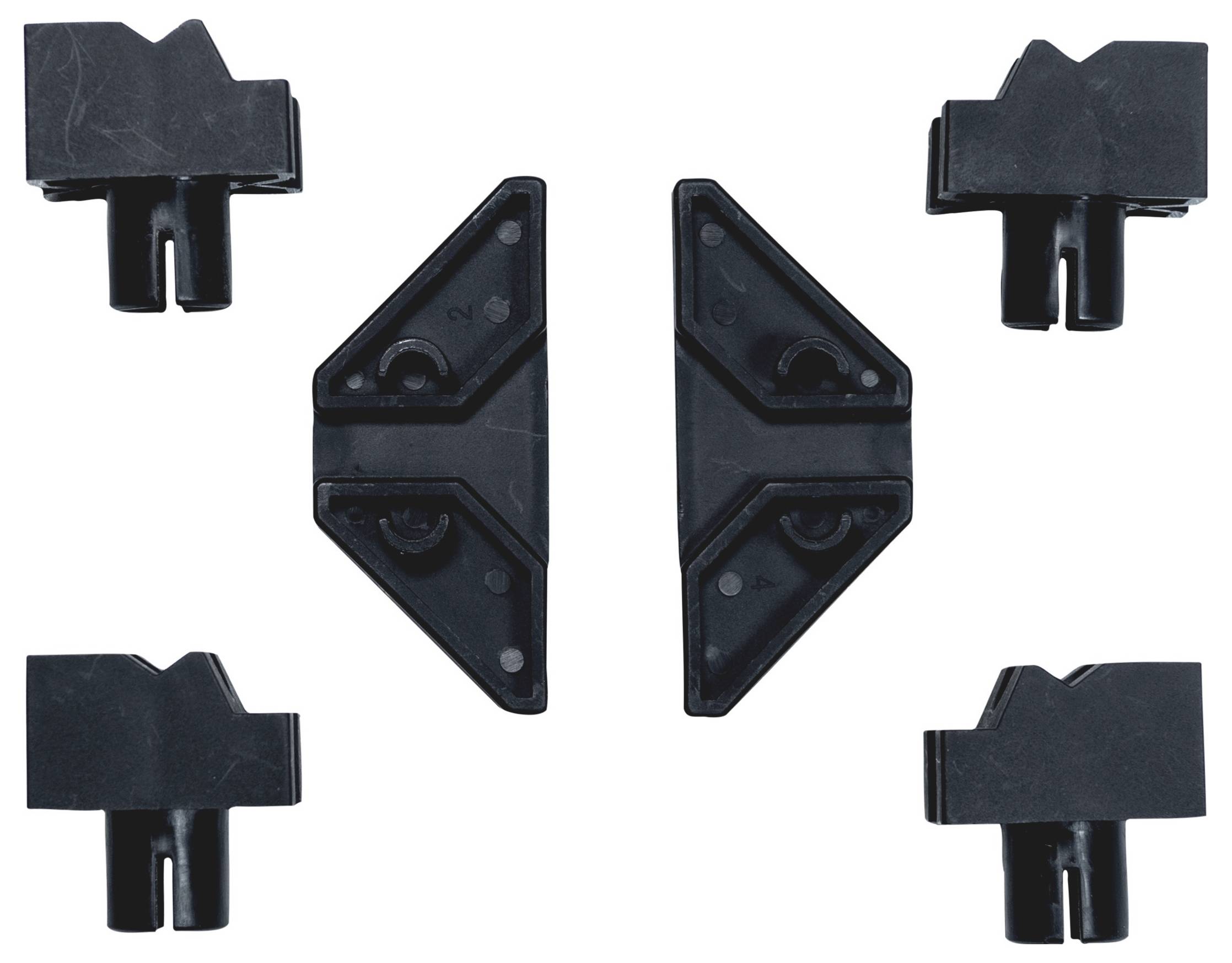 Cinque accessori in plastica nera di forme diverse, disposti simmetricamente su sfondo bianco.