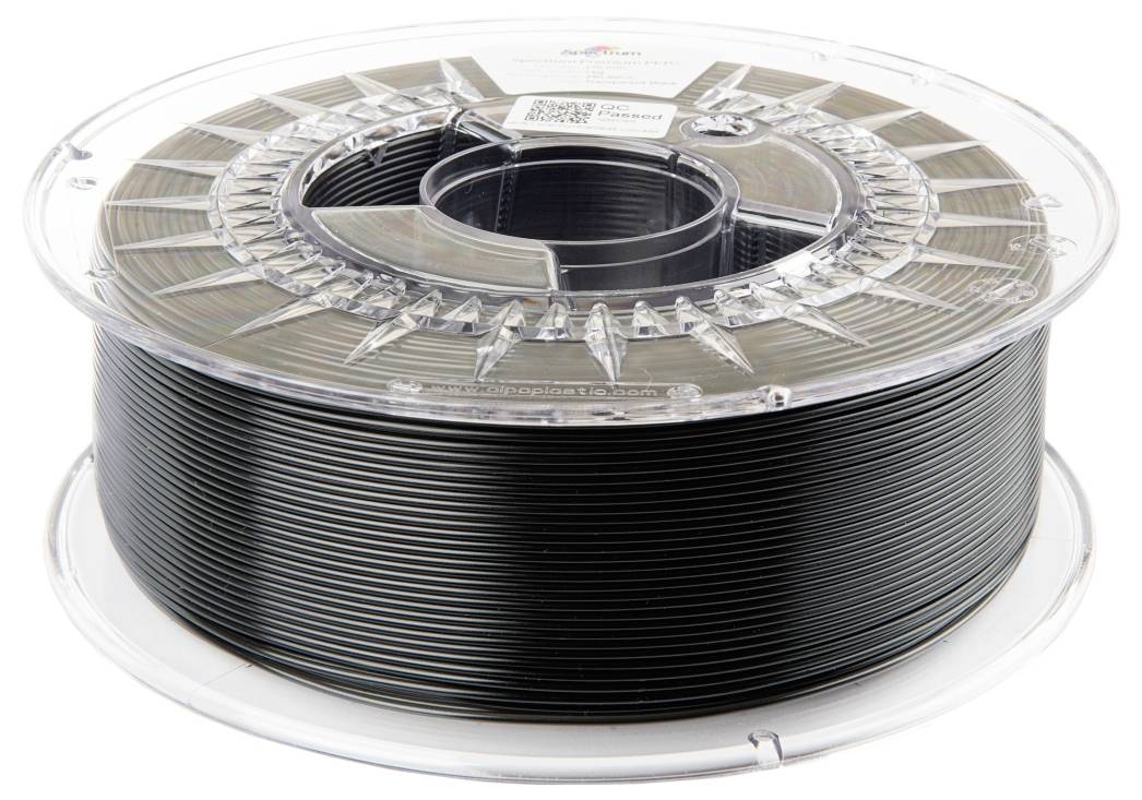 Bobina di filamento nero per stampante 3D, avvolta su un rullo di plastica trasparente.