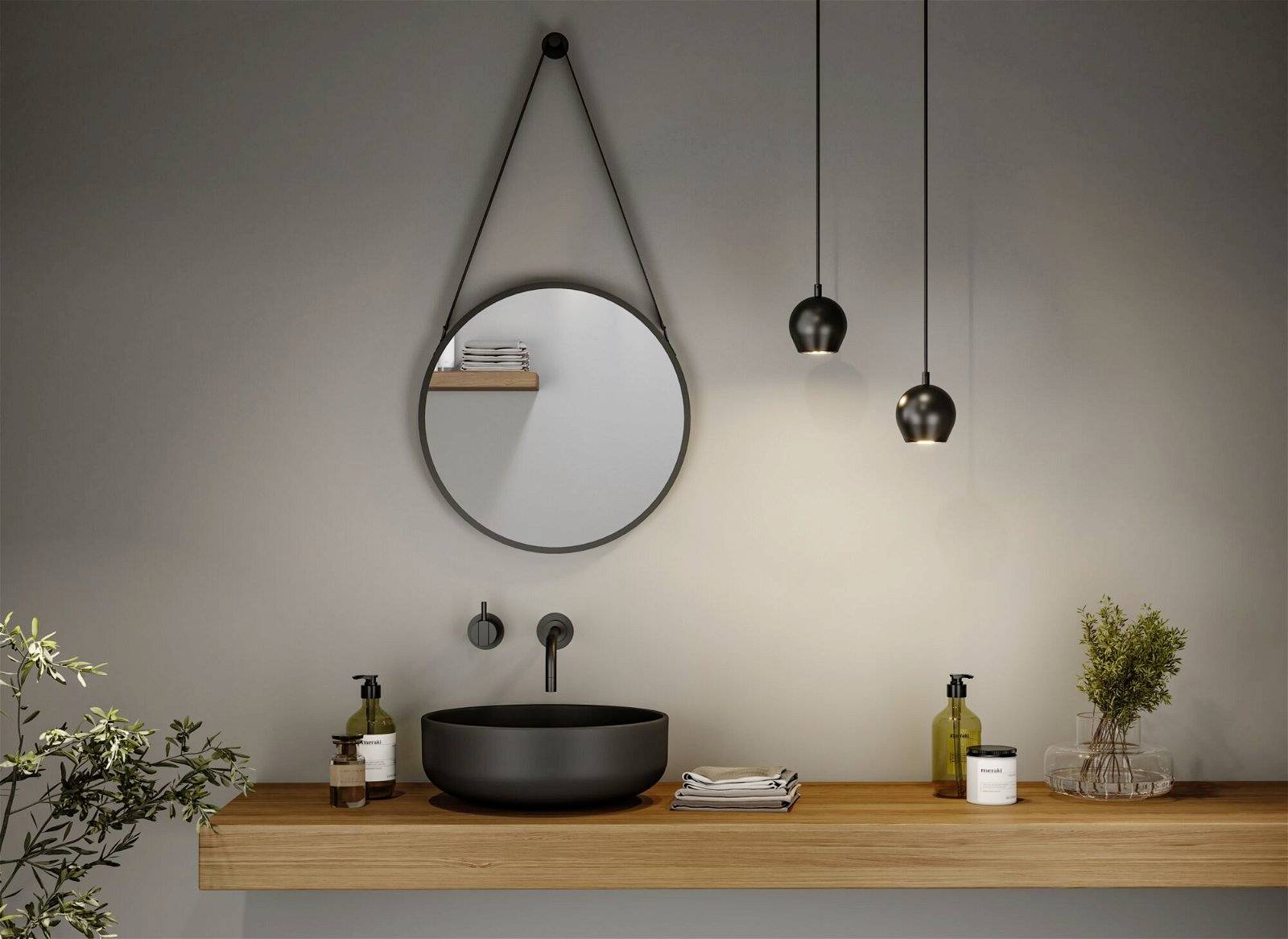 Un bagno elegante con uno specchio rotondo, un lavabo nero su un mobile da bagno in legno e lampade a sospensione.