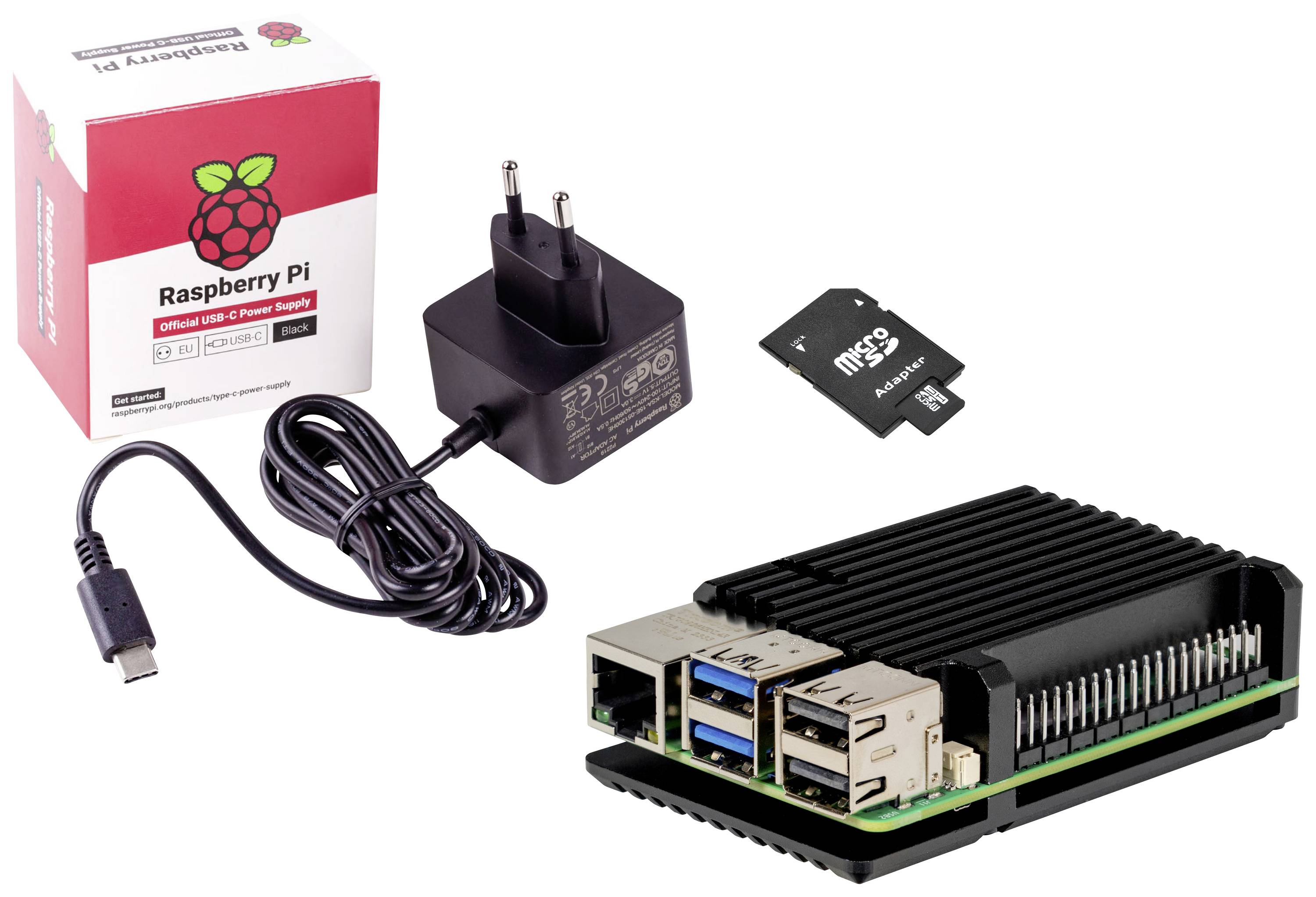 Un Raspberry Pi con dissipatore di calore, un alimentatore USB-C, una scheda microSD e una confezione con il logo Raspberry.