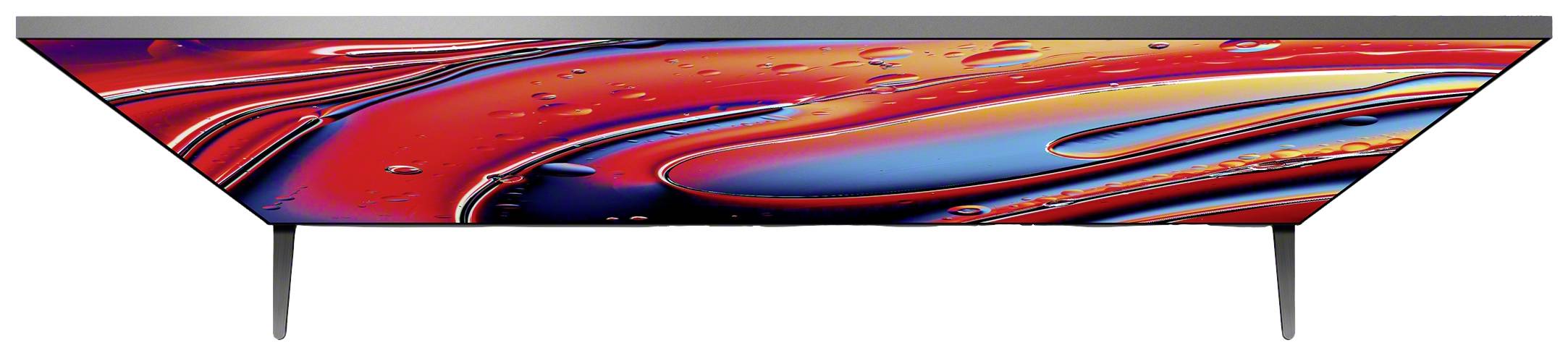 Schermo piatto con un display vivace e colorato, mostra forme astratte rosse e blu. Il dispositivo è poggiato su due piedini sottili.