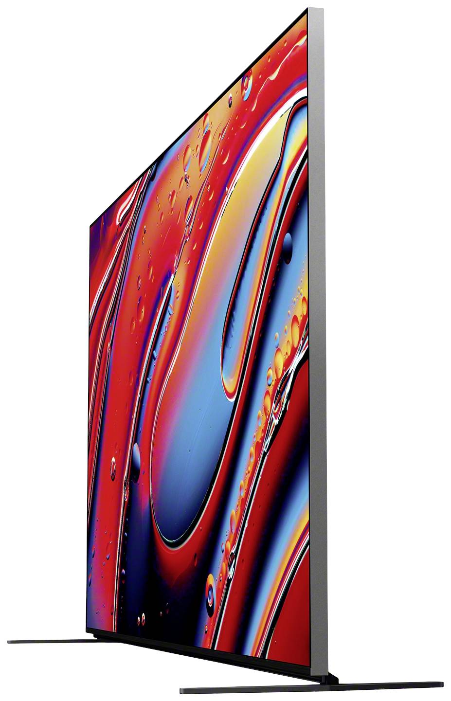 Un televisore moderno ed estremamente sottile con uno sfondo astratto e colorato in tonalità di rosso, blu e arancione, raffigurato di lato.