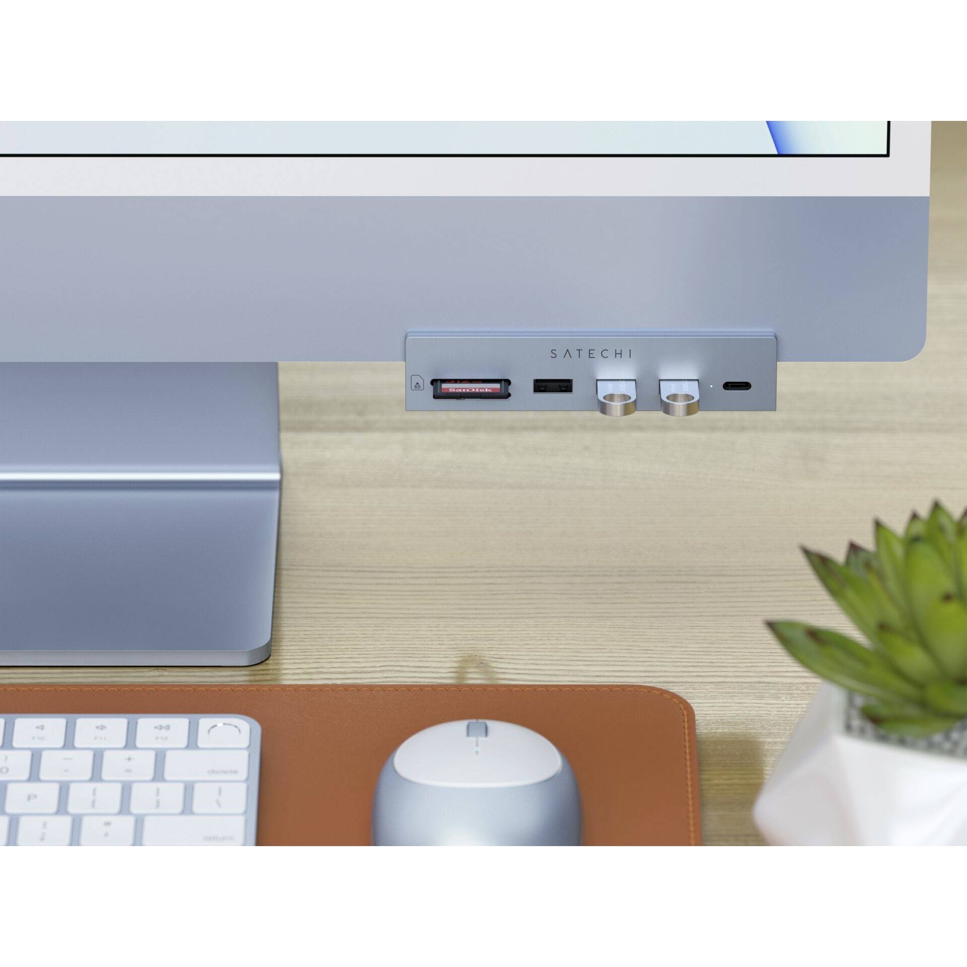 Un hub USB-C argentato su una postazione scrivania elegante con tastiera e mouse, che sottolinea la tecnologia e il design moderno.