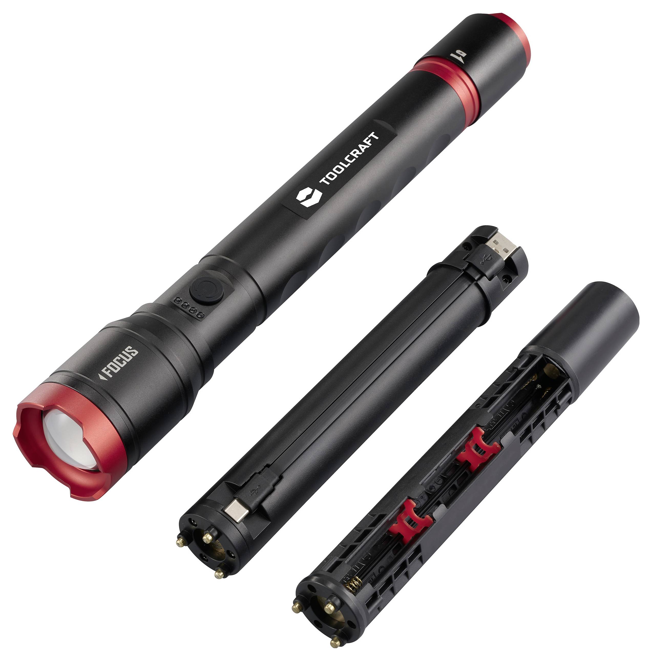 Torcia elettrica nera con bordo rosso, smontata in tre parti: corpo principale, vano batterie, tappo finale. Marca 'Toolcraft'.