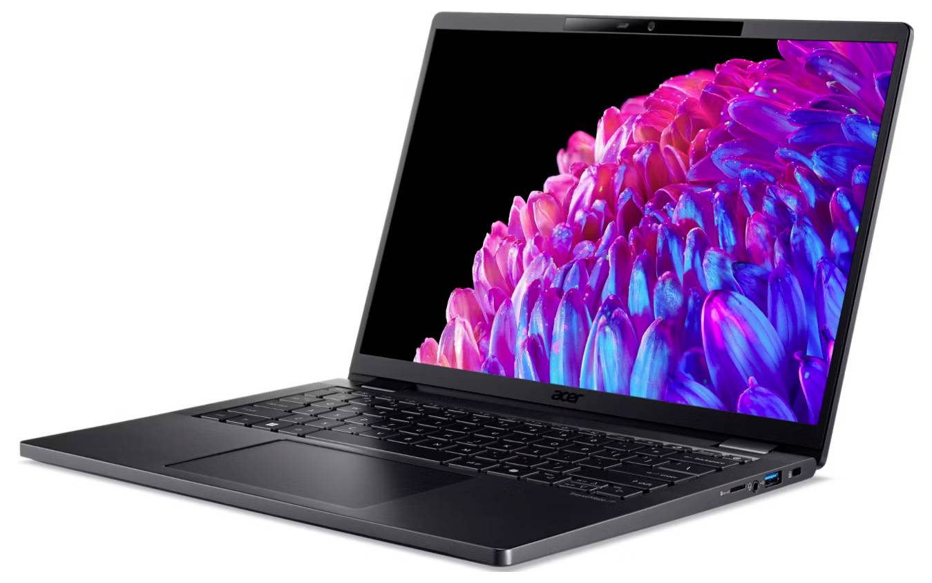 Un laptop con schermo aperto mostra un'immagine astratta e colorata con forme di fiori rosa e viola su sfondo nero.