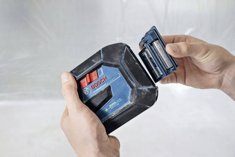 Una persona tiene un batteria Bosch Professional da 18V con un pacco batteria smontato, dimostrando le sue caratteristiche di connessione e di design.