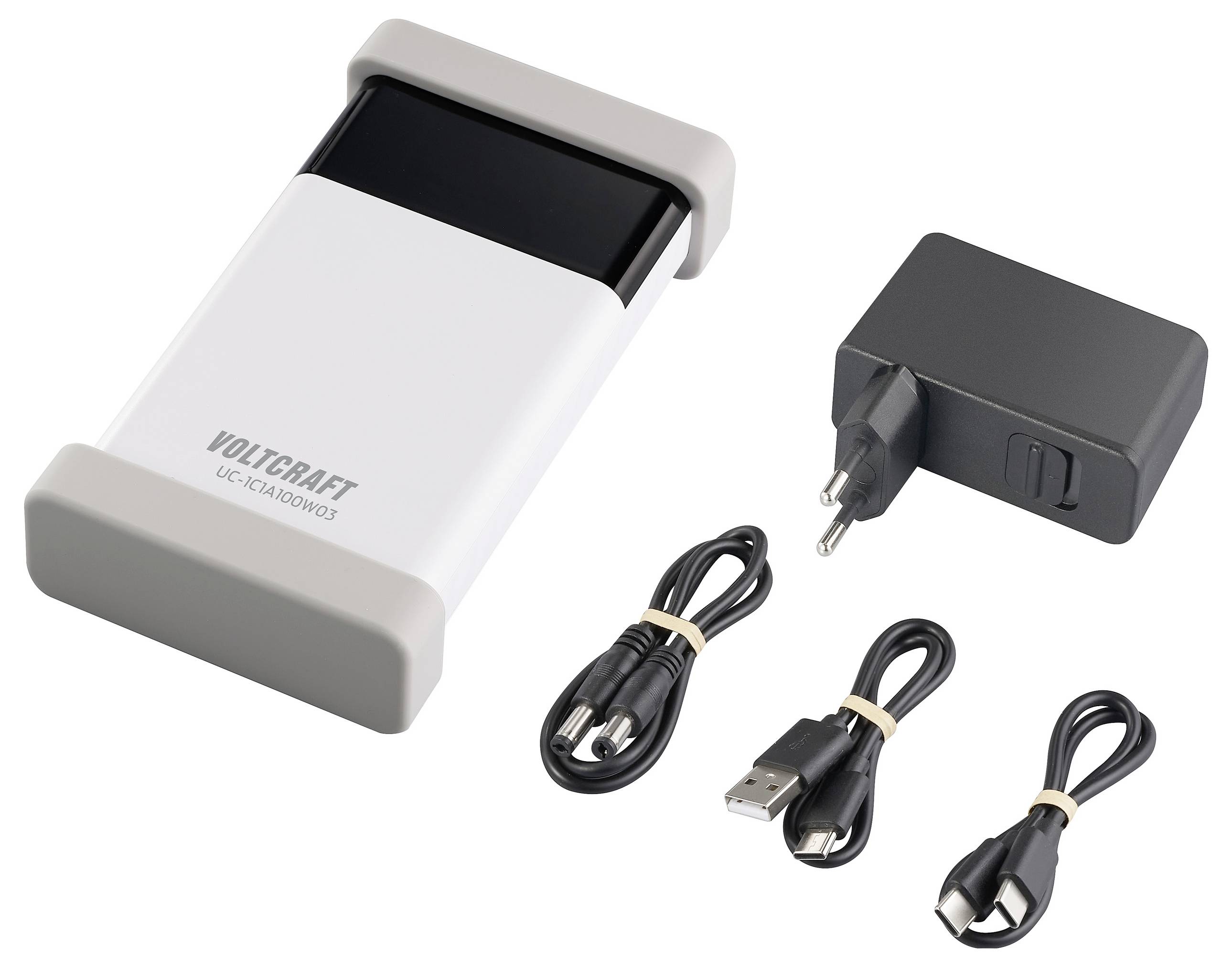 Un caricabatterie bianco e nero di Voltcraft con due cavi USB e un adattatore di rete. Ideale per la ricarica di vari dispositivi.