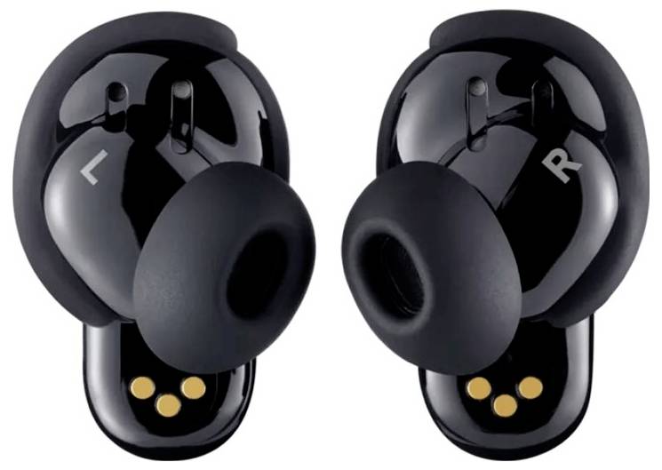 Auricolari wireless neri con etichette 'L' e 'R', con tre punti di contatto gialli sul retro di ciascuno.