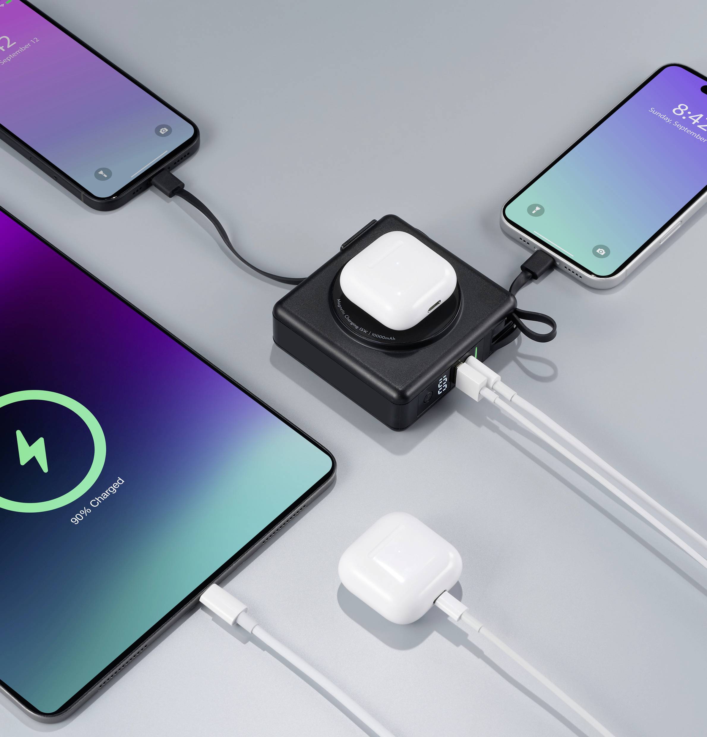 Diversi smartphone e AirPods sono collegati a un caricabatterie che sta caricando tutti i dispositivi contemporaneamente. Stati di carica differenti.