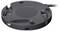 Dispositivo rotondo di colore nero-grigio con diversi porte, tra cui USB e HDMI, posizionato su una superficie liscia.