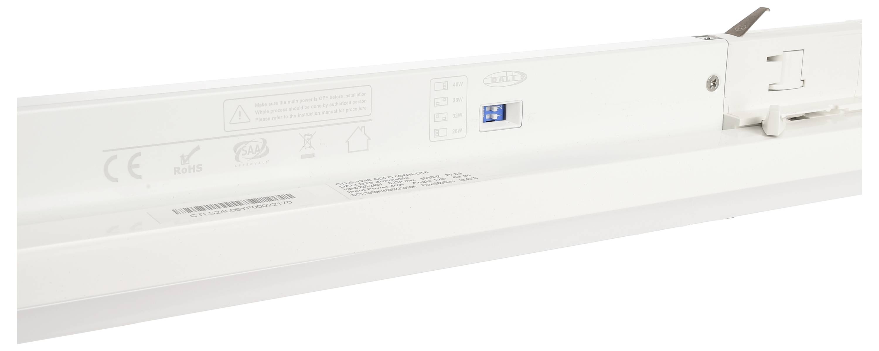 Un dispositivo elettrico bianco con un piccolo interruttore blu e simboli e avvertenze in rilievo sul lato sinistro.