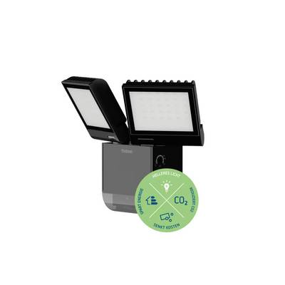 Un proiettore LED nero con due luci. Un adesivo verde mostra simboli per il risparmio energetico, luce più chiara e ridotte emissioni di CO2.