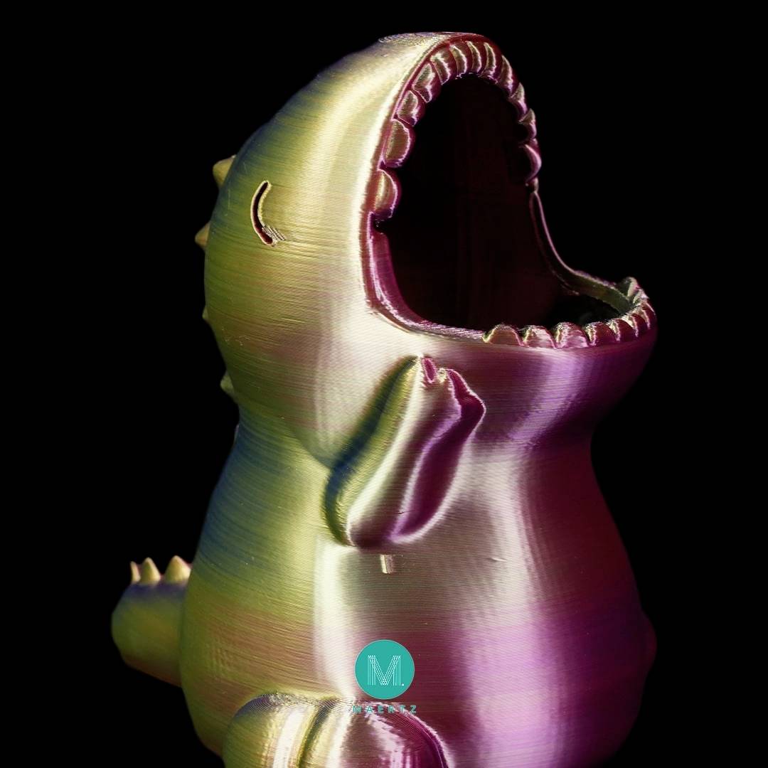 Figura colorata e lucente di un ippopotamo stilizzato con la bocca spalancata, priva di funzione visibile o contesto specifico.