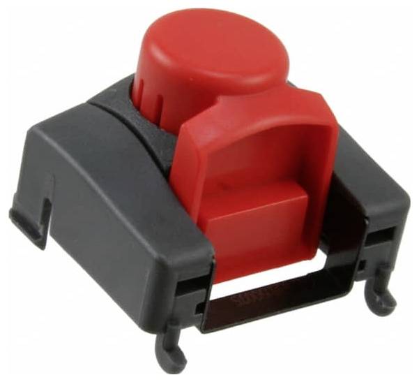 Un pulsante rosso su una base di plastica nera con piccoli ganci di montaggio, utilizzato in elettronica per attivare circuiti o fornire input.
