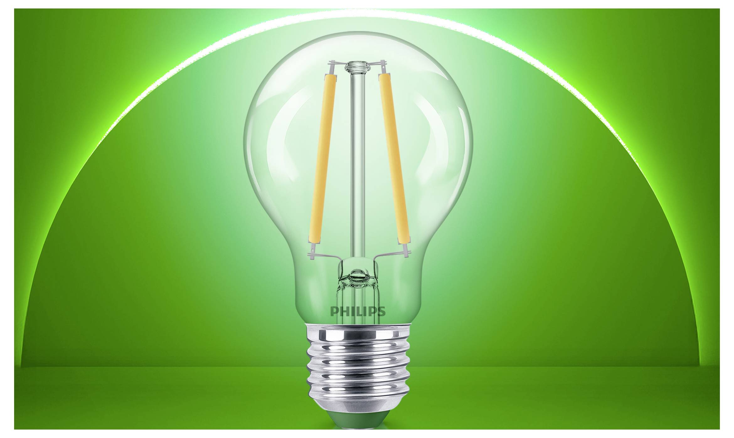 Una lampadina Philips trasparente centrata su uno sfondo verde brillante, mostrata come immagine di prodotto.