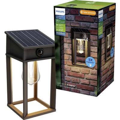Lampada da parete alimentata ad energia solare Philips con cornice a lanterna in metallo nero e lampadina a vista, mostrata accanto alla sua confezione di vendita su sfondo bianco.