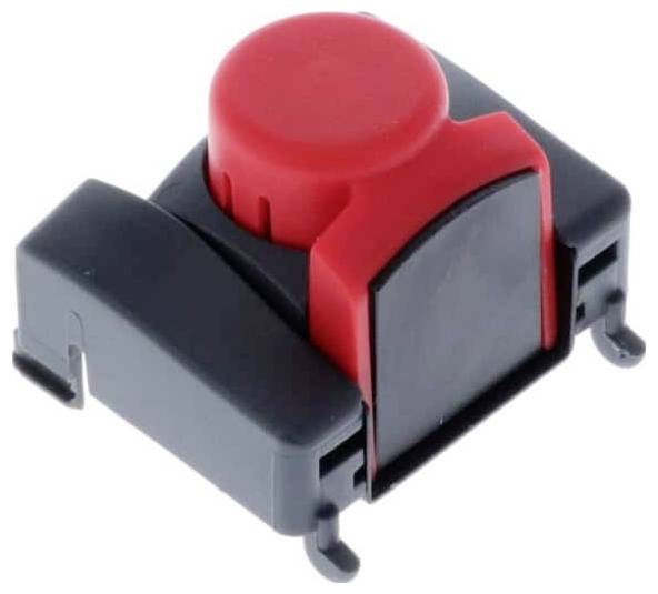 Un pulsante di commutazione rosso alloggiato in un involucro nero, comunemente utilizzato nei dispositivi elettronici per l'attivazione di circuiti.