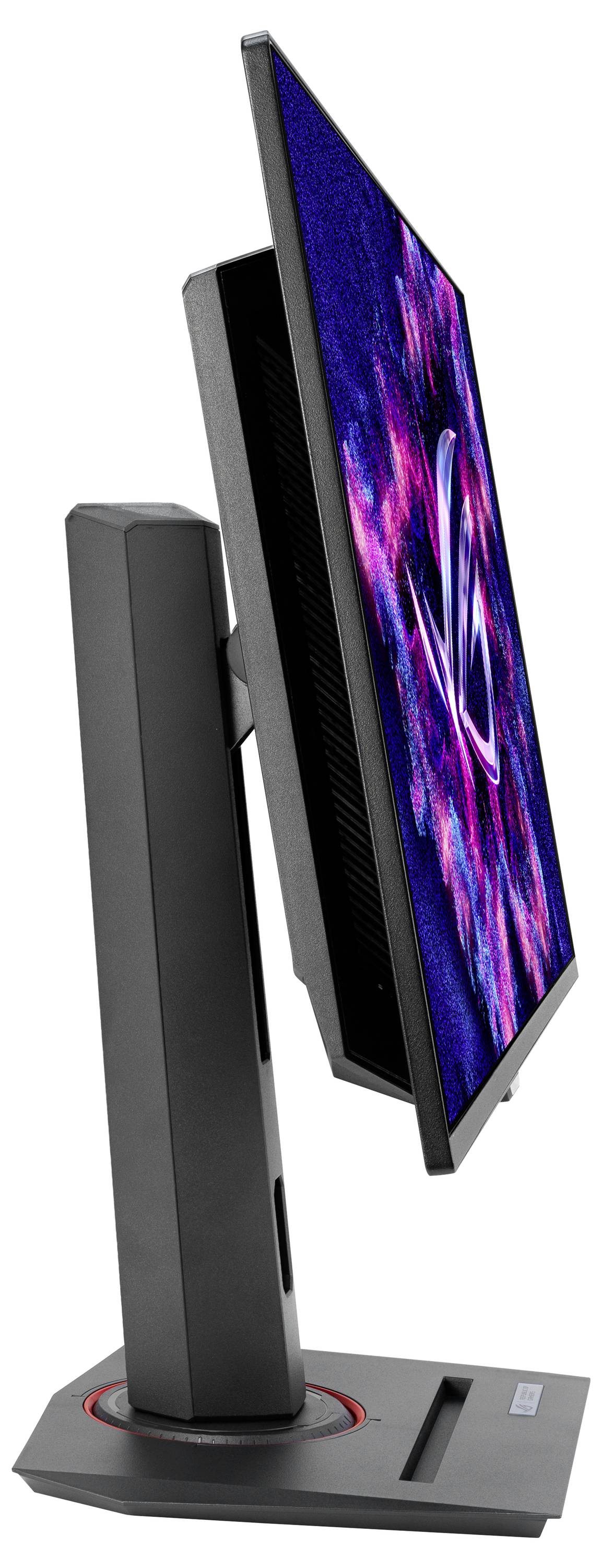 Un monitor per computer nero e grigio, fotografato di lato, mostra un pattern astratto blu e rosa sullo schermo.