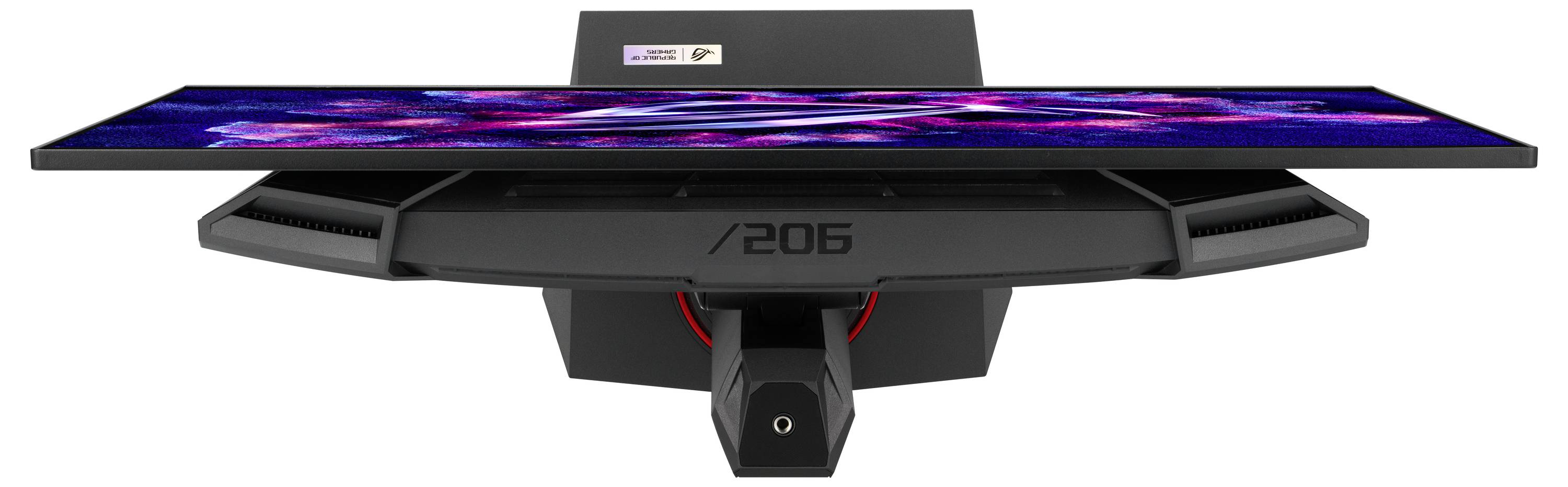 Un monitor da gaming mostrato frontalmente e dal basso, con schermo illuminato in colori vivaci e fessure di ventilazione sui lati.