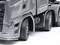 Camion grigio con logo 'BV VENTURES Heavy Haulage'. Mostra le ruote anteriori e posteriori su sfondo bianco.