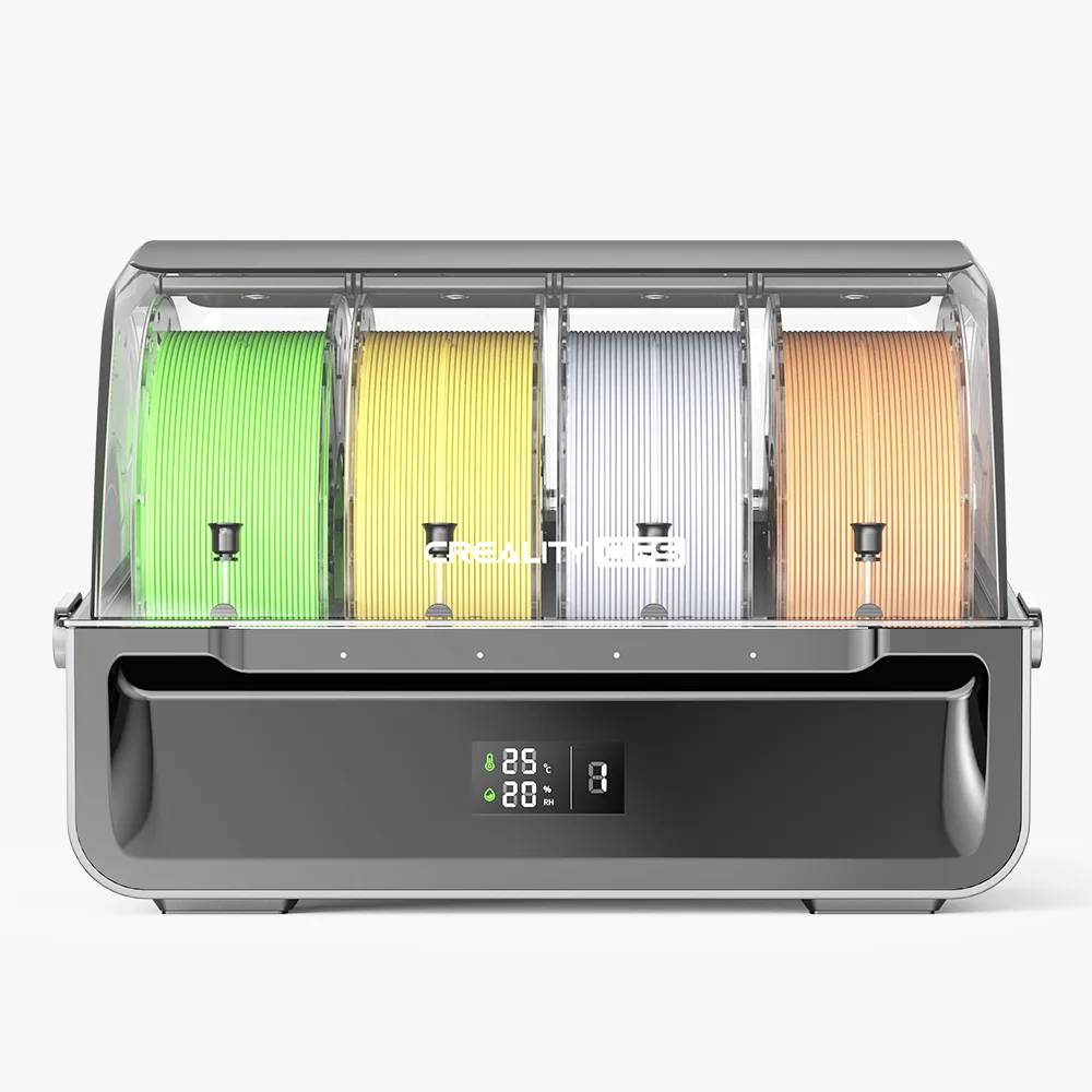 Essiccatore per filamenti da stampa 3D con quattro camere trasparenti contenenti filamenti verdi, gialli, grigi e arancioni. Display LED in basso che mostra la temperatura.