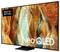 Un grande televisore con cornice sottile mostra un'immagine astratta dai colori brillanti. Scritta: 'Made for Germany' e 'Neo QLED'.
